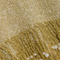 Close-up of the Simkhai Tali Pearl Fringe Top, a metallic gold bouclé knit fabric featuring long gold fringe embellished with round white pearls.
