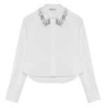 Simkhai Renata Embellished Collar Cropped Shirt in white, featuring a button-down design and a collar adorned with silver beaded fringe.