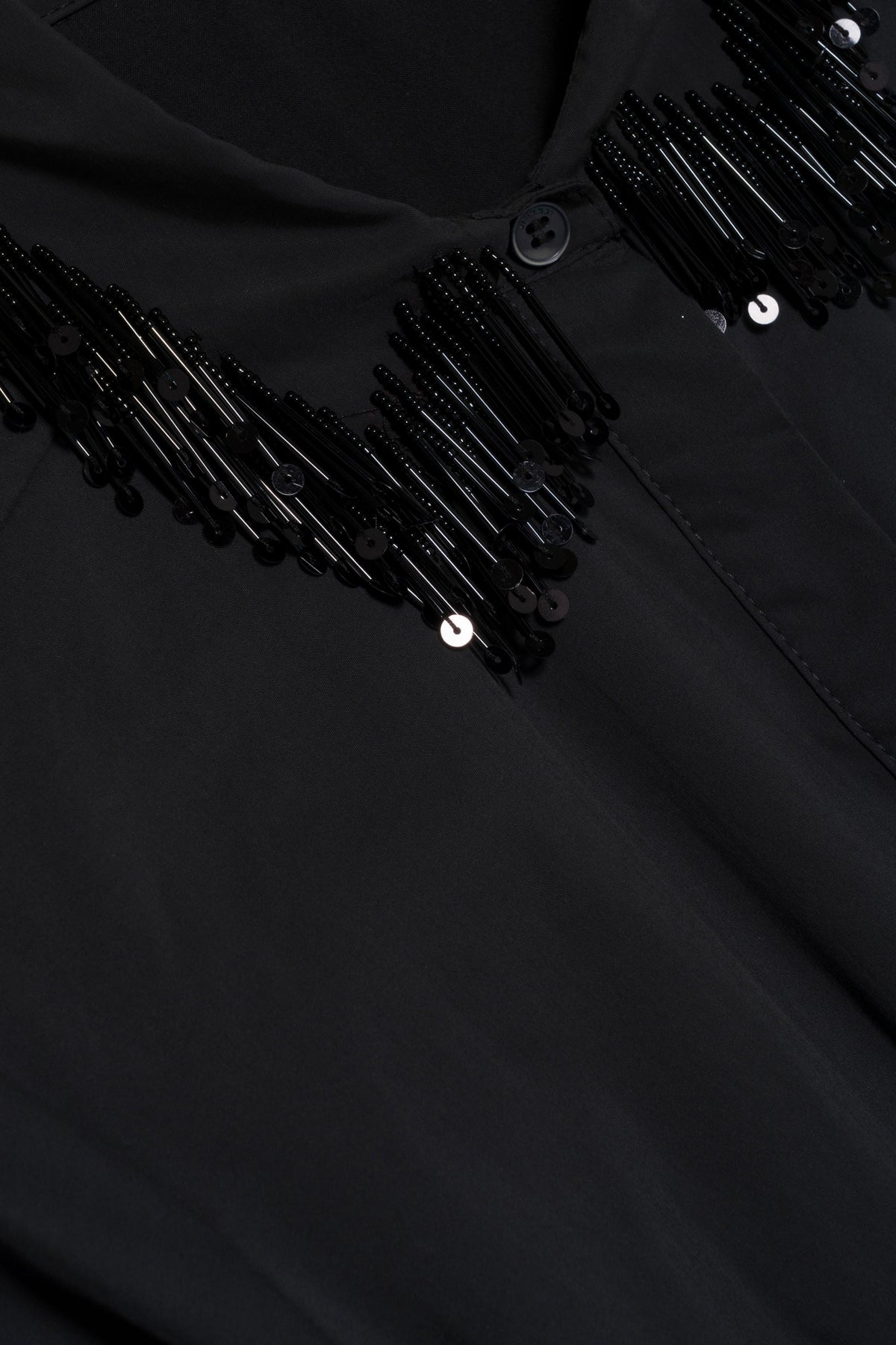 Close-up of a black Jazz Embellished Collar Midi Dress by Simkhai, featuring a collar with black bead and sequin fringe detailing.