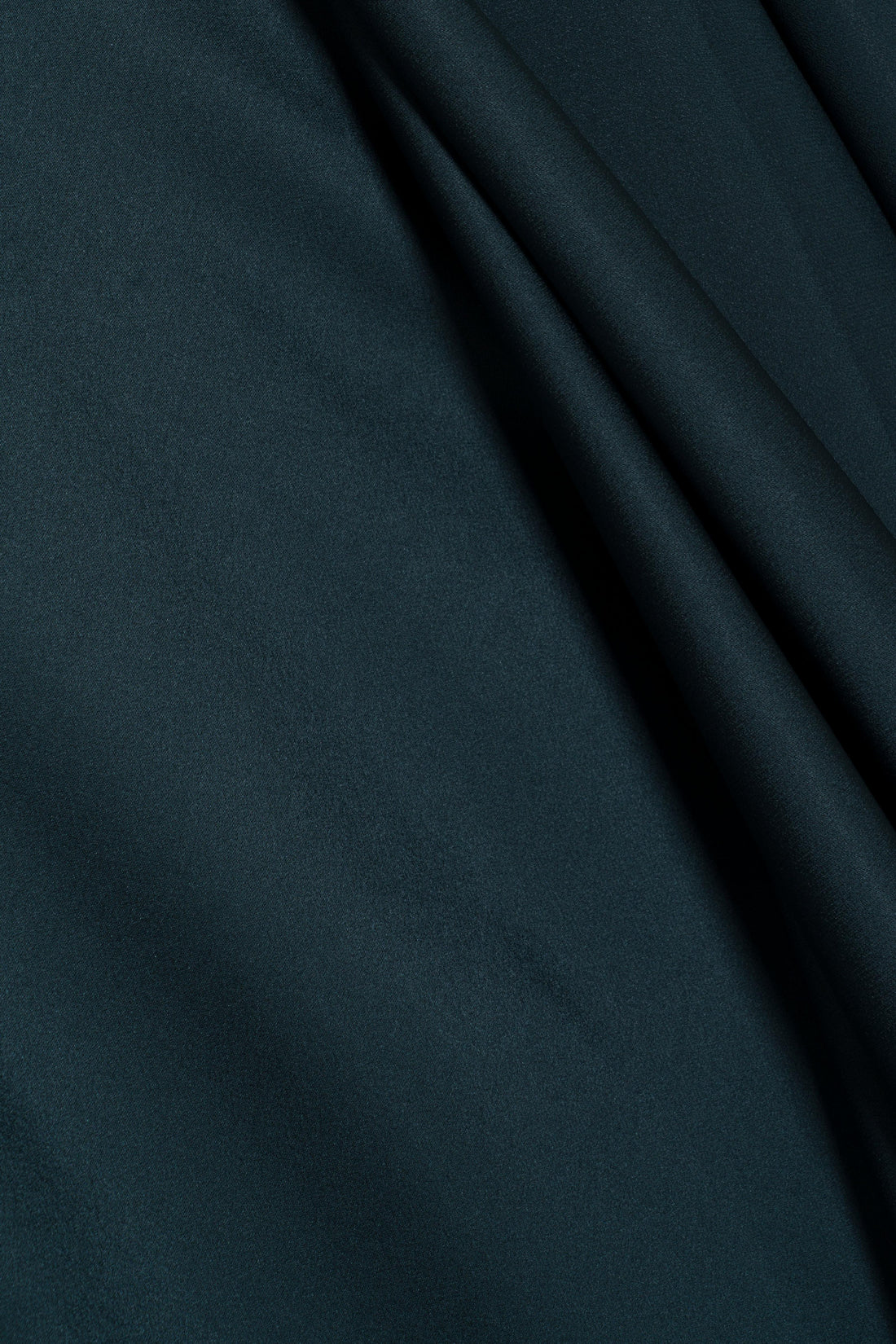 Deep teal satin fabric of the Simkhai Ora Satin Gown featuring soft, asymmetrical folds.