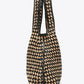 The Crochet Raffia Market Tote by 3.1 Phillip Lim features a black and beige geometric design, two handles, and a structured rectangular shape—making it the perfect stylish shopping tote for carrying your everyday essentials.