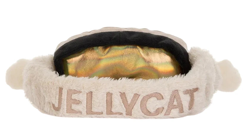 Jellycat Amuseables Sports Ski Club Goggles plush toy with a reflective gold lens, black trim, and a cream-colored fleece strap embroidered with the brand name.