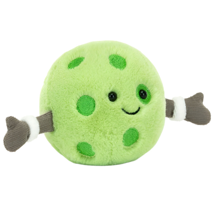 Jellycat’s Amuseables Sports Pickleball is a round, green plush with embroidered spots, a smiling face, and two outstretched arms with brown hands—perfect for pickleball or sports fans!.
