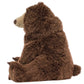 Bizzlestomp Bear by Jellycat—a plush brown stuffed animal sits upright, showing its soft fur and a gentle smile in profile.