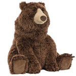 A plush Jellycat Bizzlestomp Bear sits upright, with soft fur, a round beige snout, and brown paws, angled slightly to the side against a white background.
