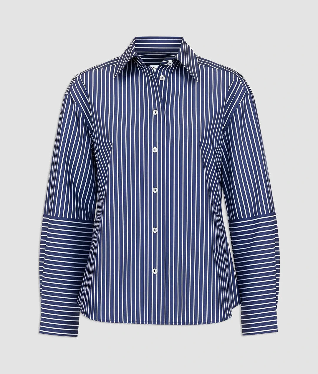 The Aura Top by Callas Milano is a long-sleeve, button-up shirt made from Italian stripe poplin with blue and white vertical stripes and contrasting horizontal stripes on the lower sleeves.