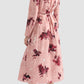 A woman is shown from the back wearing the Erdem Long Sleeve Abstract Rose Shirt Dress with a belted waist, paired with black textured flat shoes.
