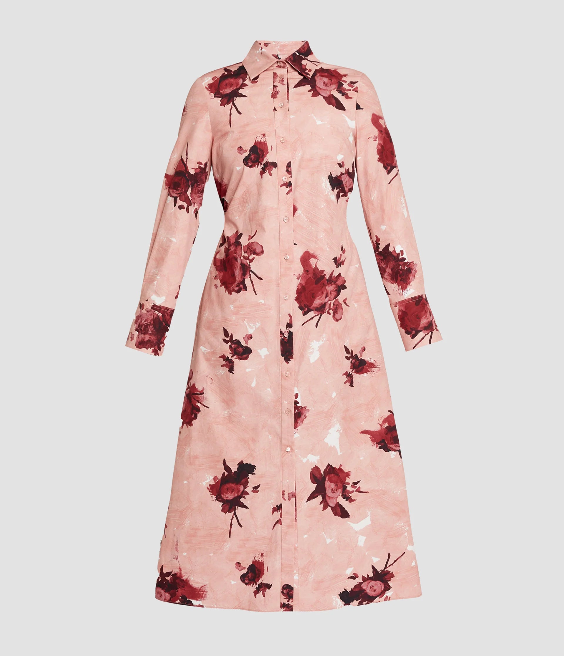The Erdem Long Sleeve Abstract Rose Shirt Dress is a pink cotton poplin shirt dress with a collar, button-down front, and red abstract rose bouquets print, shown against a plain background.