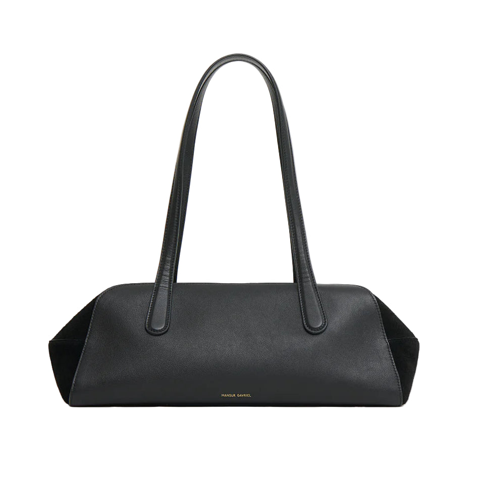 The Mansur Gavriel Helios Bag is rectangular, made of black leather, features two long shoulder straps, and has minimal gold branding at the bottom center.