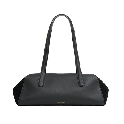 The Mansur Gavriel Helios Bag is rectangular, made of black leather, features two long shoulder straps, and has minimal gold branding at the bottom center.