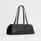 The Mansur Gavriel Helios Bag, a black rectangular handbag with long double shoulder straps and a minimalist smooth leather design, is shown against a plain white background.