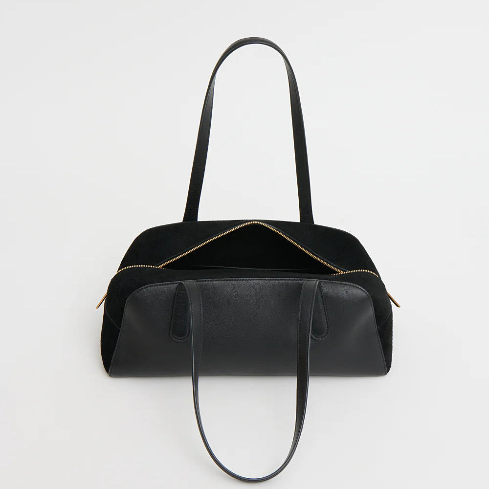 A black leather Mansur Gavriel Helios Bag with dual shoulder straps and a gold zipper, shown against a plain white background.