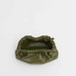 The Mini Cloud Clutch by Mansur Gavriel is an olive green, soft Italian lambskin clutch with sculptural ruching and a gathered opening, photographed on a plain white background. No straps or handles are visible.