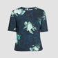 The Erdem Short Sleeve Abstract Rose Top features a round neckline, navy stretch-cady fabric, and a green and white abstract painted roses print.