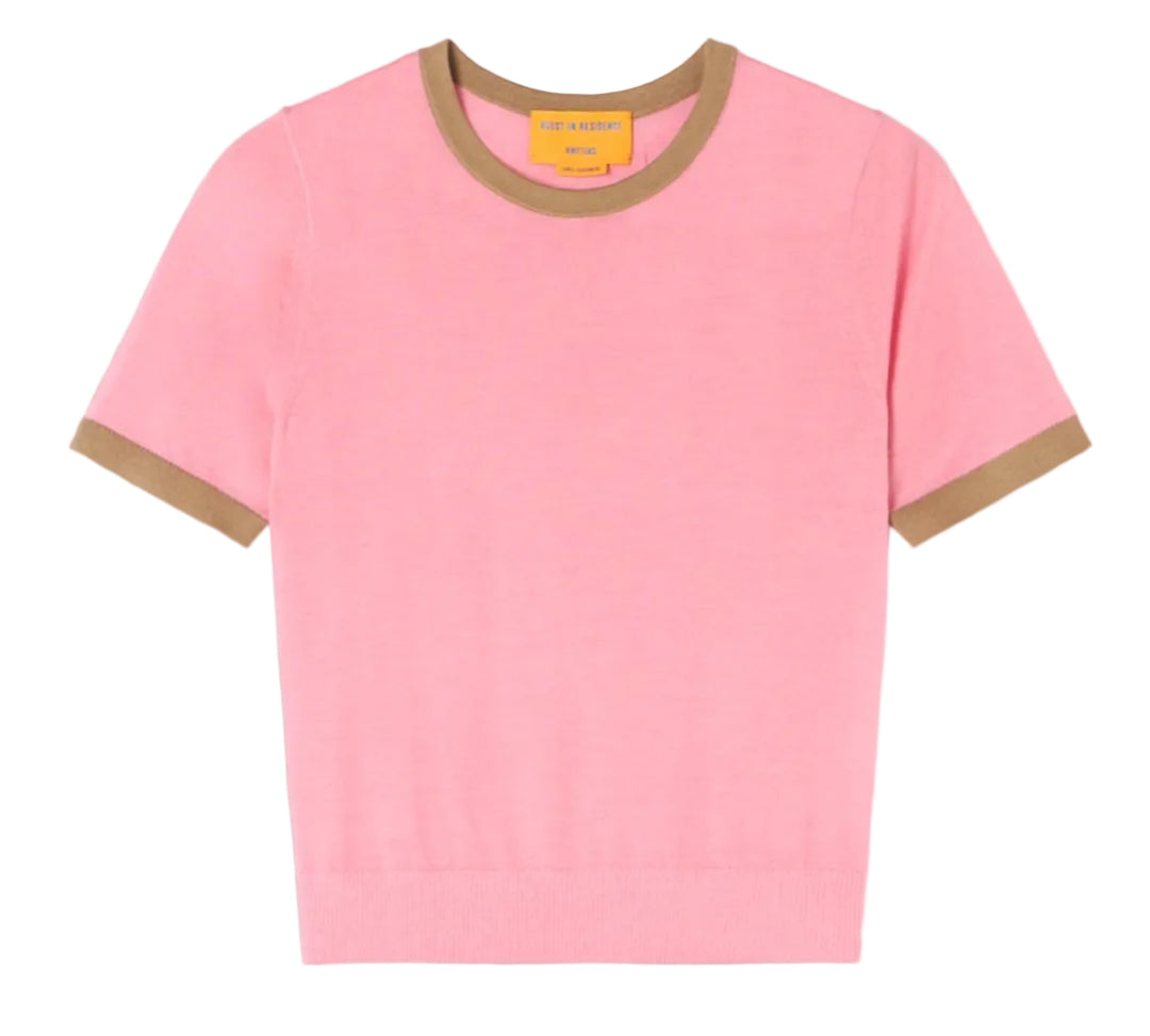 The Guest in Residence Airy Ringer Tee, a light pink short-sleeve lightweight cashmere sweater with brown trim on the collar and sleeve cuffs, is laid flat on a white background.