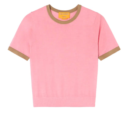 The Guest in Residence Airy Ringer Tee, a light pink short-sleeve lightweight cashmere sweater with brown trim on the collar and sleeve cuffs, is laid flat on a white background.