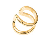 The Alma Ring by Lie Studio, featuring two parallel curved gold bands and photographed on a plain white background, highlights modern design with timeless elegance.