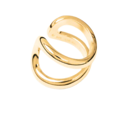 The Alma Ring by Lie Studio, featuring two parallel curved gold bands and photographed on a plain white background, highlights modern design with timeless elegance.