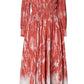 The Kathleen Dress by Altuzarra is a long-sleeve dress with a red and white tie-dye shibori pattern, featuring a deep V-neck, pleated shoulder details, and an elasticated waist for comfort.