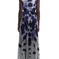 Back view of a person wearing the Altuzarra Pamela Dress, a sleeveless, pleated midi style with a sycamore ladybug print, paired with black open-toe heels.