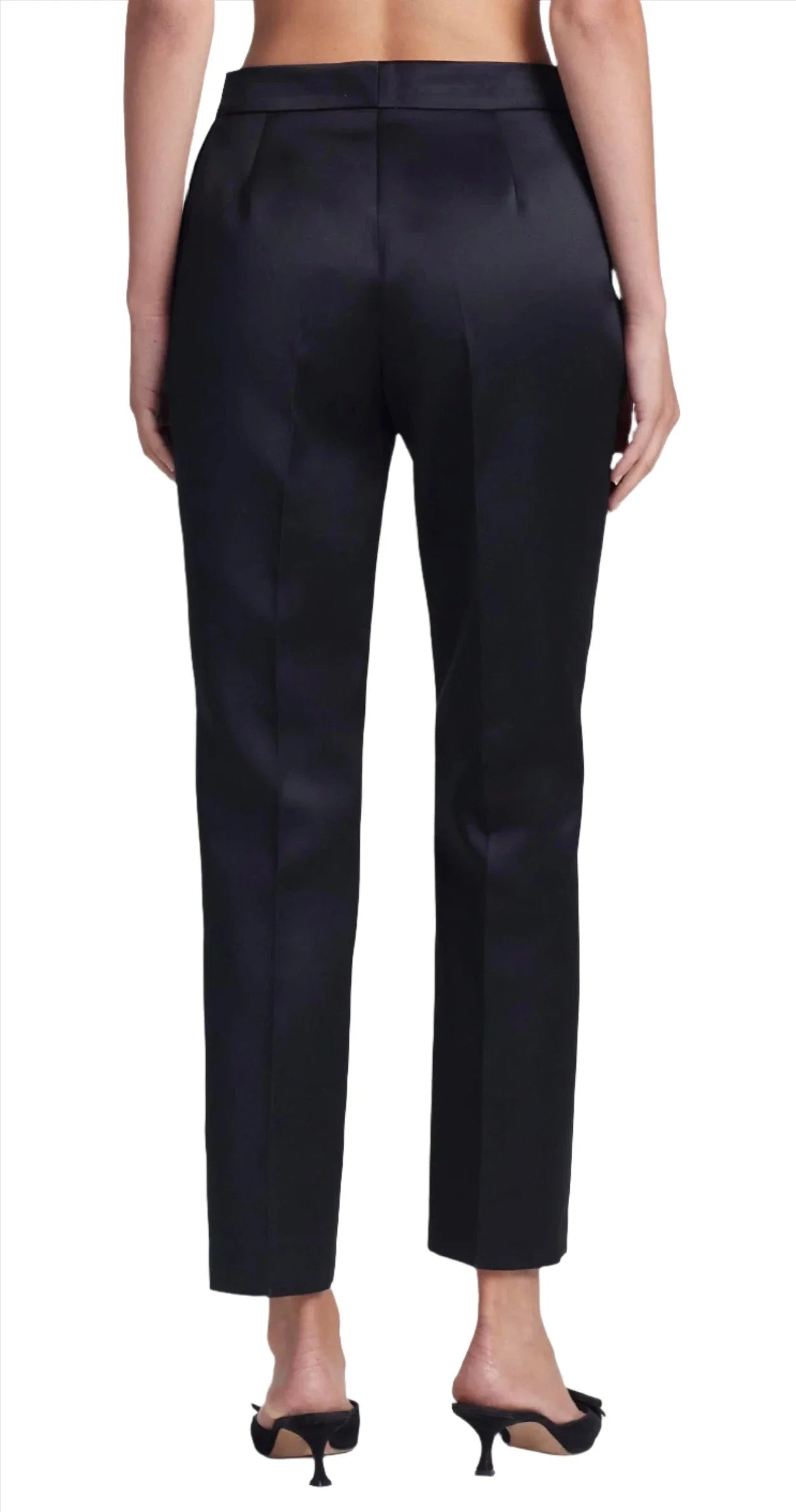 Rear view of a person wearing black Altuzarra Todd Pant with a mid-rise waist and black high-heeled sandals.