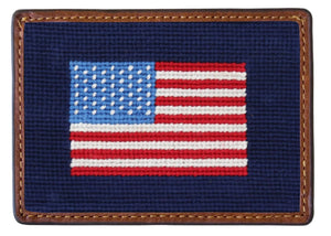 The Smathers & Branson American Flag Card Wallet features a stitched American flag design on navy blue, framed by a brown hand-stitched leather border.