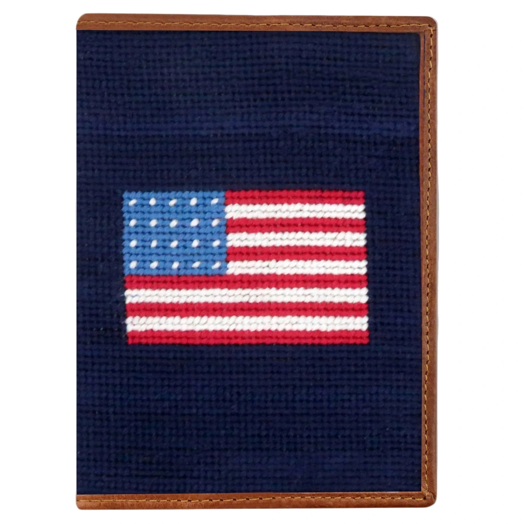 The Smathers & Branson American Flag Passport Case features a small rectangular needlepoint design with an American flag on a dark blue background and fine Italian leather trim—ideal as a travel organizer.