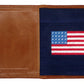 The Smathers & Branson American Flag Passport Case is crafted from brown Italian leather with a stitched American flag on a navy interior and the brand embossed on the corner, making it a stylish way to organize your travel essentials.