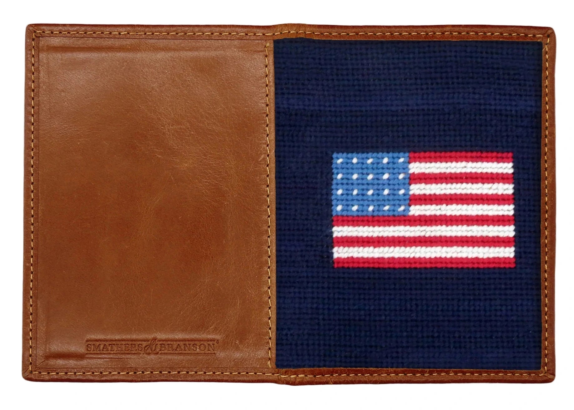 The Smathers & Branson American Flag Passport Case is crafted from brown Italian leather with a stitched American flag on a navy interior and the brand embossed on the corner, making it a stylish way to organize your travel essentials.