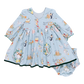 A Pink Chicken Baby Girl Amma Dress in light blue, featuring a festive pattern of animals and musical instruments reminiscent of the 12 Days of Christmas, comes with matching bloomers.