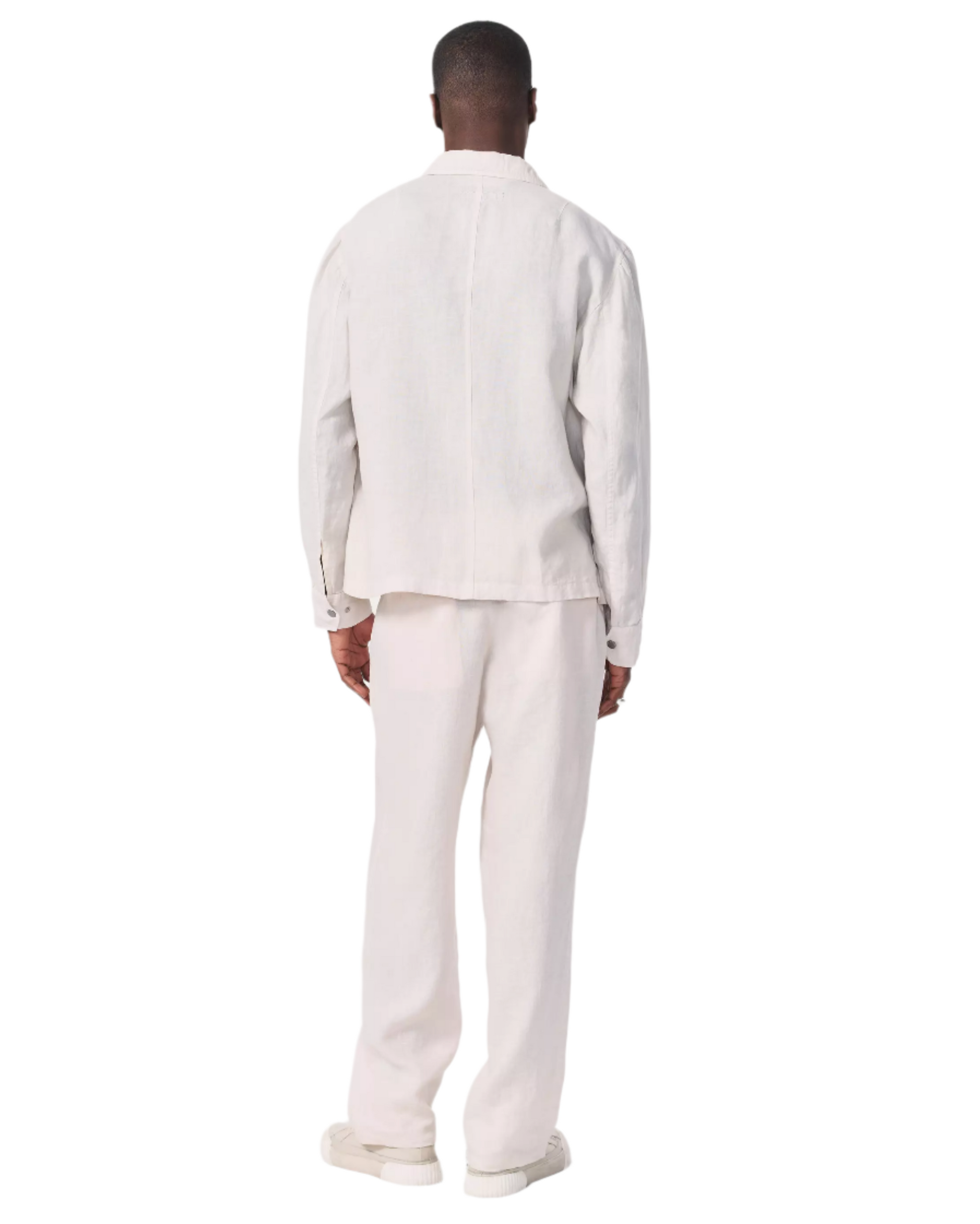 A person faces away, wearing the Rag & Bone Angus Linen Shirt Jacket with matching pants and light shoes, set against a white background.