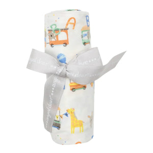 Introducing the Angel Dear Animal Train Swaddle Blanket, a soft, rolled-up baby blanket featuring delightful animal and vehicle prints. It's tied with a light gray ribbon, making it perfect for versatile swaddles and cozy snuggles.