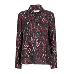 The Ansel Printed Soft Twill Top by Proenza Schouler White Label features a red, black, white, and teal abstract pattern. This long-sleeve top is crafted from soft printed twill and offers a loose fit with a flattering cowl turtleneck for added comfort and style.