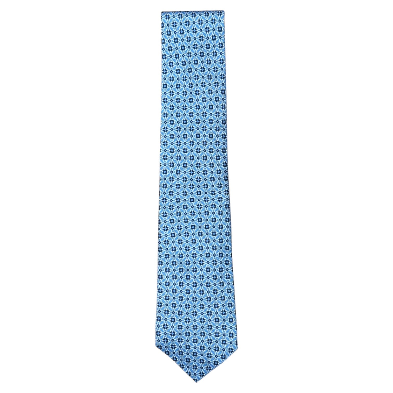 The Atomic Diamond Tie by Robert Jensen is a light blue silk tie with a dark blue geometric pattern and hand-stitched details, shown on a white background.