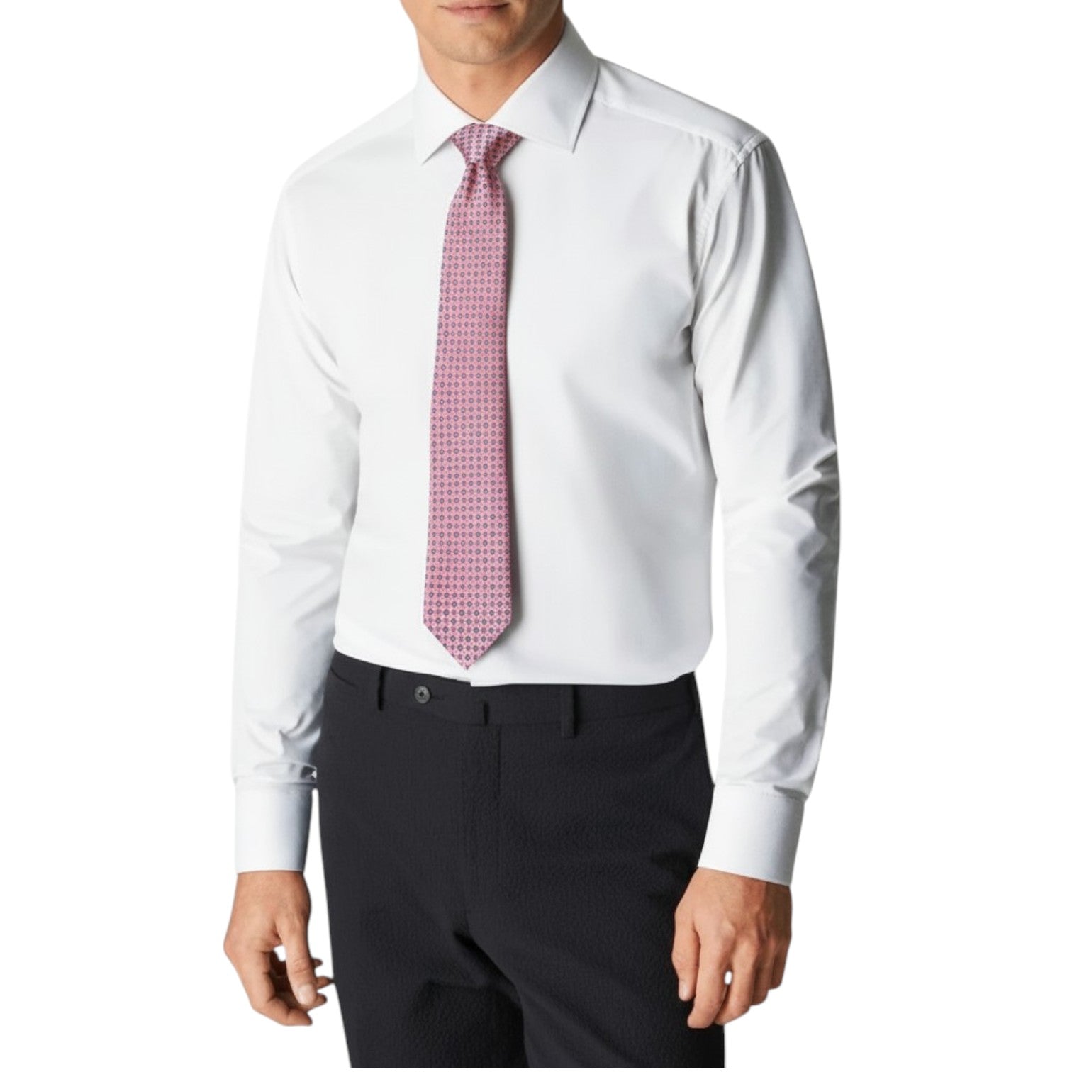 A man is shown from shoulders to waist against a plain background, wearing a white dress shirt, black trousers, and the Robert Jensen Atomic Diamond Tie in pink patterns.