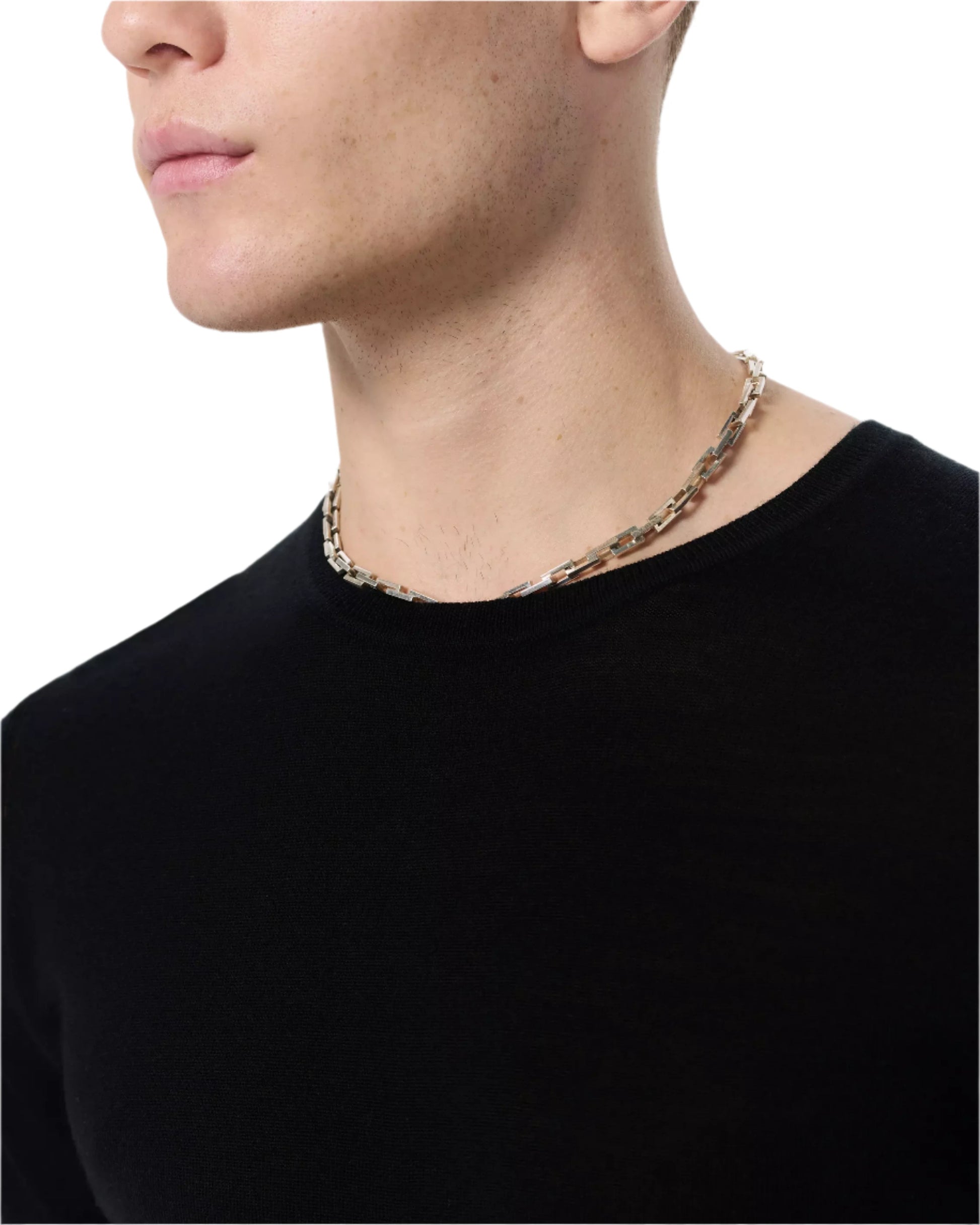 A person wearing the Rag & Bone Aulton Knit Tee in black and a silver chain necklace, shown from the shoulders up against a plain background.