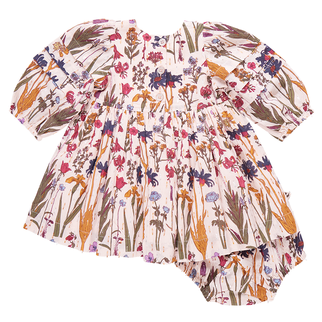 The Pink Chicken Baby Girls' Brooke Dress Set by Pink Chicken features a floral printed dress with puffy sleeves and matching bloomers, showcasing Prairie Blossoms in a mix of colorful flowers and green leaves.