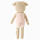 Ava the Cow Powder Pink by Cuddle + Kind is a 20" knitted plush toy featuring cute horns, ears, and a tail in a powder pink outfit with cream trim—perfect for birthday cuddles or playtime in a sweet berry meadow.