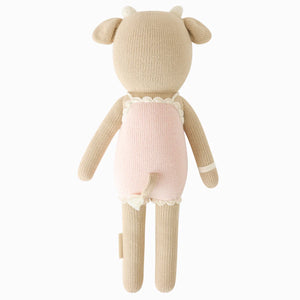 Ava the Cow Powder Pink - Little 13" by Cuddle + Kind, shown from behind with beige horns and limbs, a light pink dress with cream trim, and a small tail—an adorable plush doll and perfect birthday gift for friends.