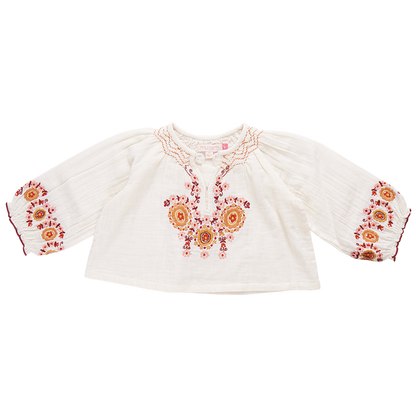 A white, long-sleeve Pink Chicken Girls' Ava Top in toddler size, featuring vibrant orange and pink floral harvest embroidery on the chest and cuffs, perfect for a touch of boho fashion.