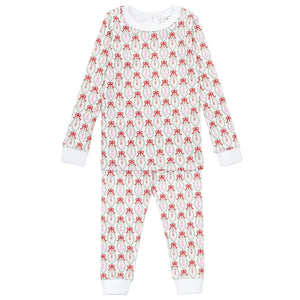 The Girls' Ava Pajama Pant Set by Lila & Hayes is a long-sleeve, full-length Peruvian cotton set with a red bow pattern on white and white cuffs at the wrists and ankles.