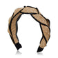 The Ava Band by Gigi Burris is a handcrafted straw headband with a braided design and black trim, exemplifying the brand's polished style.