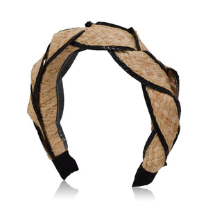 The Gigi Burris Ava Band highlights exquisite millinery craftsmanship with its handcrafted braided design made from raffia straw and enhanced with black accents.