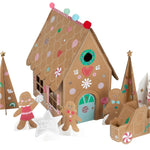 The Meri Meri Gingerbread Sticker Advent Calendar, by the brand Meri Meri, features a cardboard gingerbread house adorned with festive decorations and accompanied by charming cutout gingerbread people, trees, and a truck. Its whimsical designs make it an ideal decoration for the holiday season.