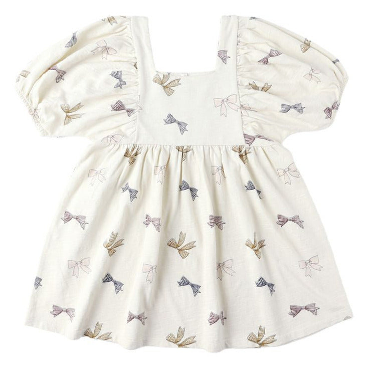The Baby Girls' and Girls' Brea Dress by Rylee & Cru is a cream, short-sleeved dress with a square neckline, empire waist, gathered skirt, and small multicolored bow pattern.