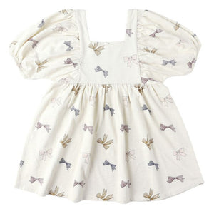 The Baby Girls' and Girls' Brea Dress by Rylee & Cru is a cream, short-sleeved dress with a square neckline, empire waist, gathered skirt, and small multicolored bow pattern.