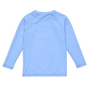 The Snapper Rock Boys' LS Rash Top in light blue is shown laid flat with the back facing up, featuring simple stitching and no visible logos—perfect for sun safety.