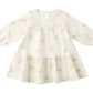 The Quincy Mae Baby Girls’ and Girls’ Tiered Jersey Dress features a cream color, long sleeves, a flared skirt with small bunny face prints, and comes with coordinating bloomers for an adorable look.