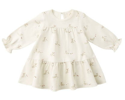 The Quincy Mae Baby Girls’ and Girls’ Tiered Jersey Dress features a cream color, long sleeves, a flared skirt with small bunny face prints, and comes with coordinating bloomers for an adorable look.