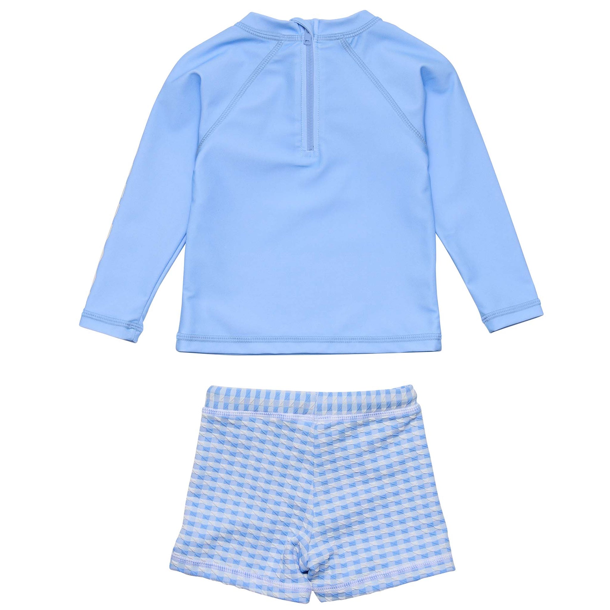 The Snapper Rock Baby Boys' Swaside Blue LS Let features a light blue long sleeve rash top with a back zipper and blue-white gingham swim shorts with an elastic waistband—a stylish, comfortable swim set.